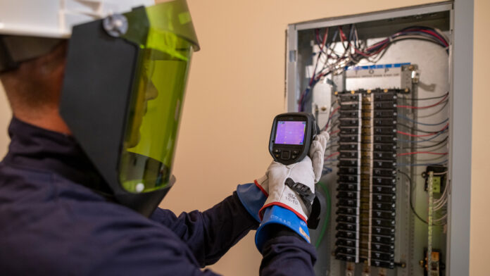 business_journal_image_lemberg_1280x720 Service Electrician Sean McFadyen performing Infrared(IR) Scanning on an electrical panel.