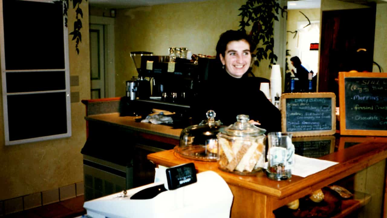 Lynn Wroblewski stands behind the counter at Fiddleheads’ first location, in Thiensville, on opening day December 1996.