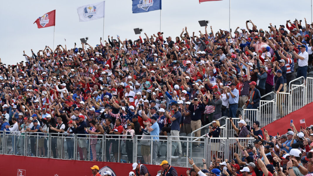 The crowd goes wild on hole 17 after Collin Morikawa sank his putt to clinch the win for Team USA.