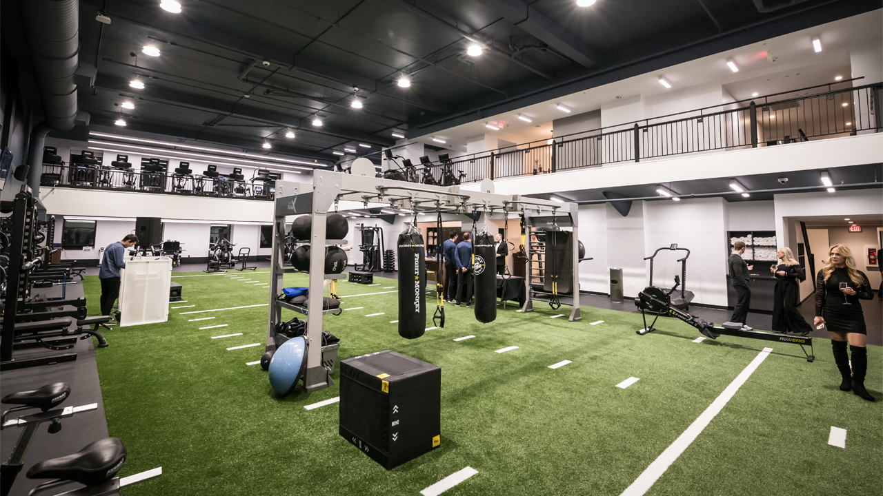 Milwaukee Athletic Club members and guests tour the brand-new, turf-covered training center at the newly renovated building on April 9. The room sits on top of one the building’s swimming pools. Contractors filled the pool with large foam blocks, and then covered those with a slab.