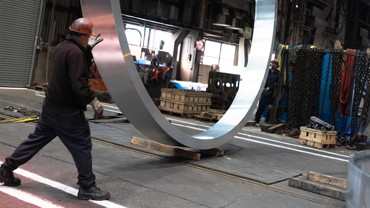 An ATI employee transports one of the finished aluminum barrel rings. 