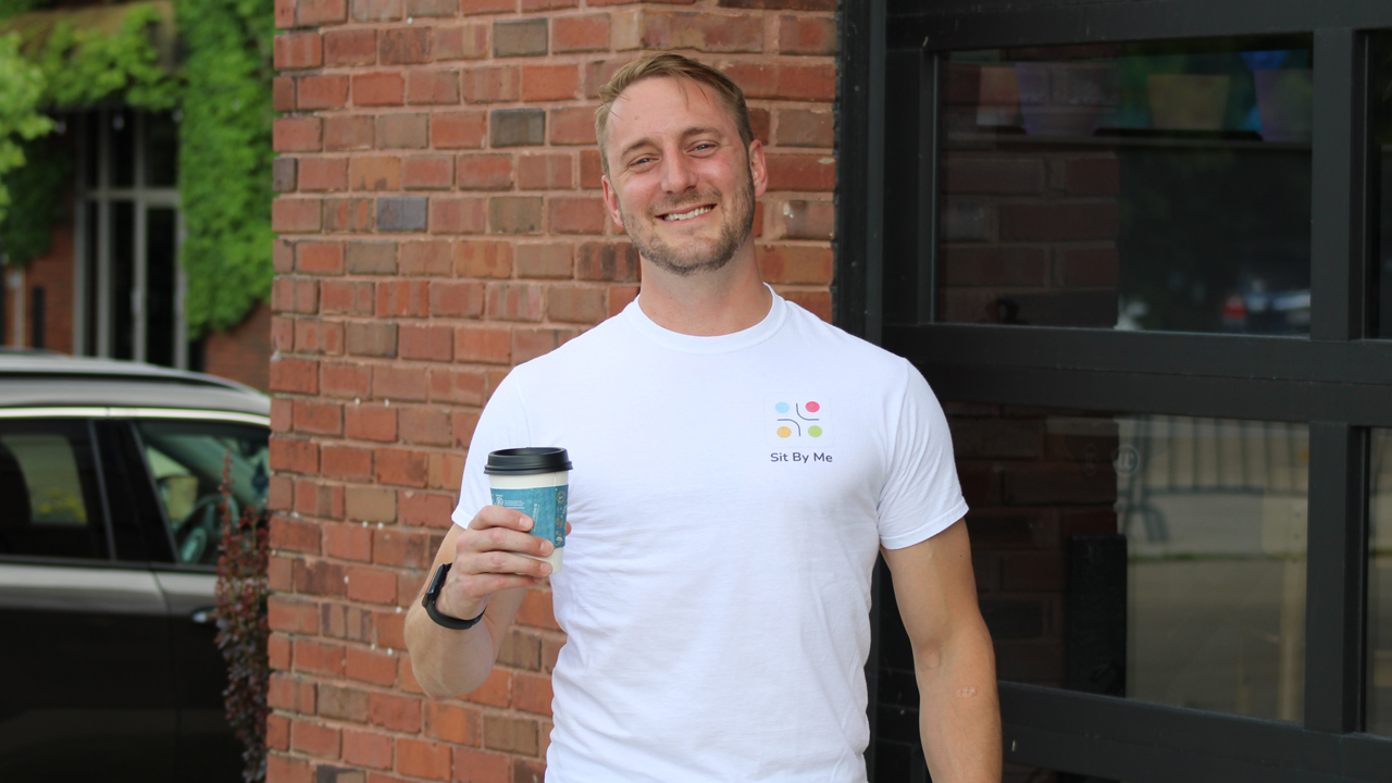 Brad Steckart stands outside of Wantable Cafe, a partner of Sit By Me.