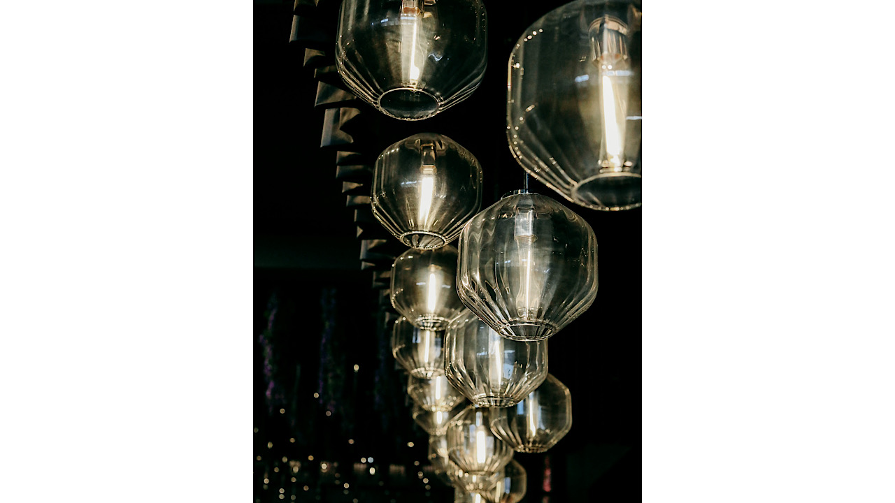 Forty pendant light fixtures hang from the ceiling of The Conroy's dining area. Photo credit: Volante Group