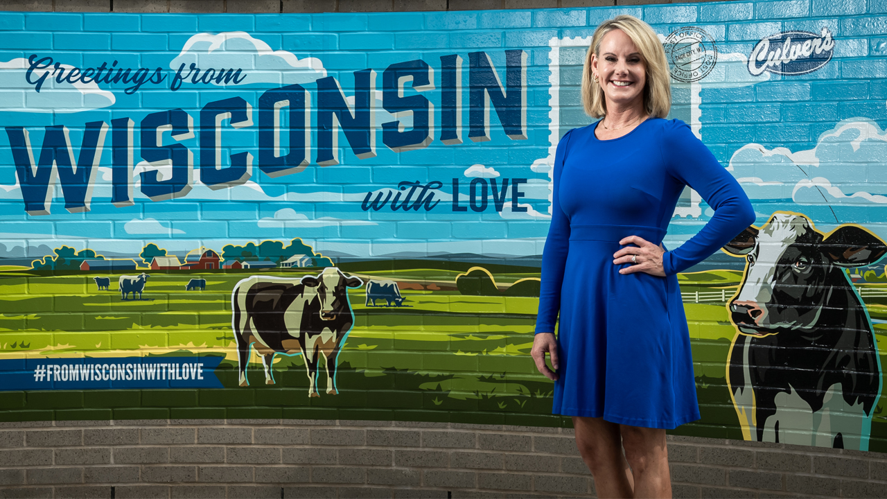 Culver’s CEO Julie Fussner in front of a mural at its restaurant in Sauk City.