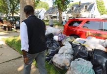Milwaukee County Executive David Crowley examining storm damage early last week.