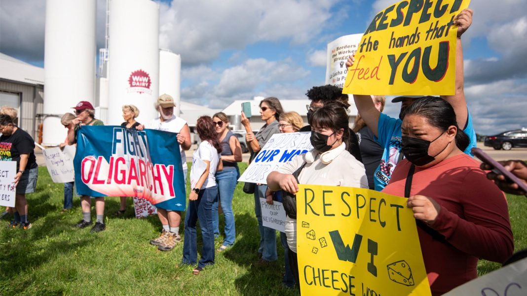 Protesters gather in support of striking workers Aug. 19 at W&W Dairy in Monroe. The company’s new owner recently implemented E-Verify to check workers’ immigration status, prompting the strike.