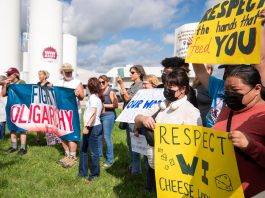 Protesters gather in support of striking workers Aug. 19 at W&W Dairy in Monroe. The company’s new owner recently implemented E-Verify to check workers’ immigration status, prompting the strike.