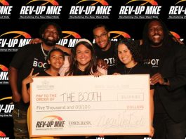 Molly Howard (front, center) and Benjamin Biddle (back, right) are pictured with their family members after winning the 2025 Rev-Up MKE pitch competition.