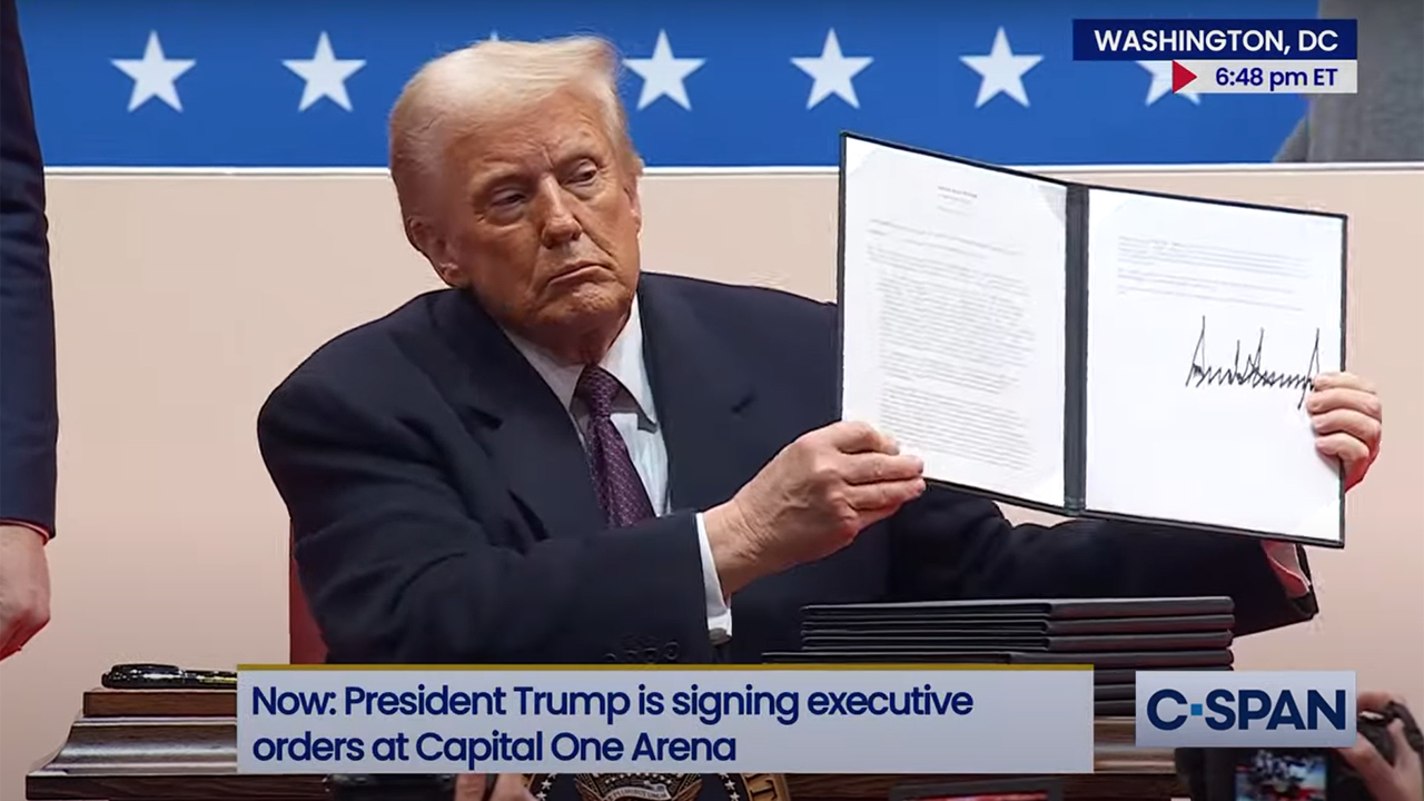 President Donald Trump shows off a signed executive order on Jan. 20 at Capital One Arena in Washington D.C. Several immigration-related orders and proclamations were signed that day.