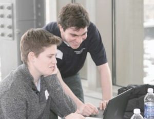 Marquette senior Dana Morgan (l) and junior Grant Younger (r) work on their team’s winning entry in social robotics. PHOTO: Dr. Jay Goldberg