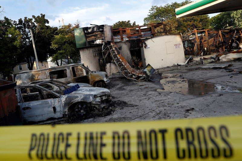 A gas station is seen burned down after disturbances following the police shooting of a man in Milwaukee, Wisconsin