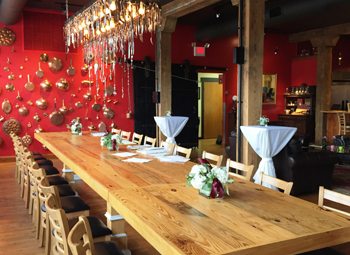 A long wooden table stretches across the north side of the first floor at 500 S. Third Street. The table was handcrafted by Magnasco from one of the building’s former walls and seats as many as 34 guests.