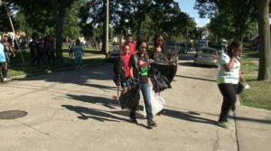 Volunteers clean up wreckage on Sunday afternoon in Sherman Park. Photo credit: WISN 12 News.