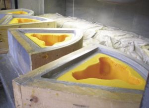 Cheeseheads dry in molds at Foamation Inc. in St. Francis.