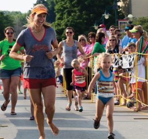 Jayme Sisel runs barefoot alongside her five-year-old daughter.