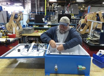 Randy Miller assembles a custom electrical control panel.