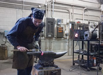 Chris Leslie works on a piece in the Scátháin metal shop.