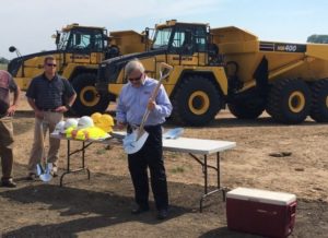 Dave Eberle, Norco Manufacturing president, receives a shovel at the ground breaking at the DeBack Farms Business Park.