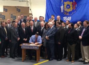 Gov. Scott Walker signs right-to-work legislation at Badger Meter in March 2015. Source: Office of Gov. Scott Walker