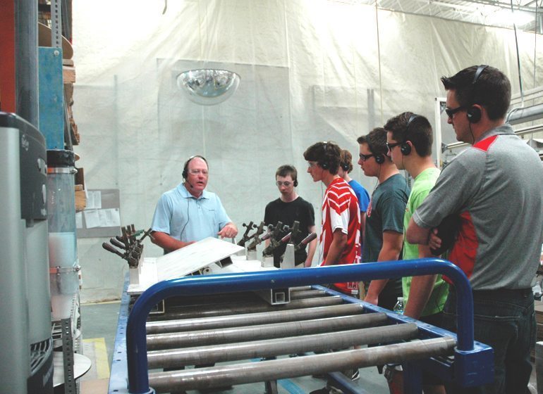 Students from Arrowhead High School participate in a tour of Menomonee Falls-based Bradley Corp., led by manufacturing supervisor Scott Krueger.