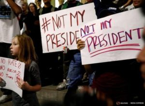 A girl joins demonstrators to protest outside of City Hall following the election of Republican Donald Trump as President of the United States in downtown Los Angeles, California November 10, 2016. REUTERS/Patrick T. Fallon