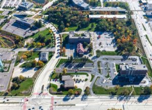 The site of the proposed development is on the left side of the picture, with the M-10 building on the upper right side of the site.