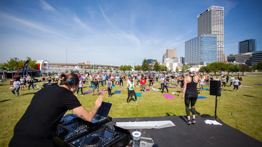 Chandler leading a workout on stage with DJ Shawna during the Rock On to Wellness event.